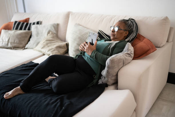 istock Senior woman holding a picture frame missing someone at home 1356378464