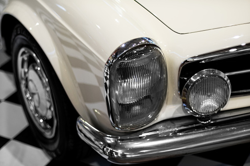 Izmir, Turkey - June 21, 2021: Close up shot of a Mercedes-Benz's Pagoda 280 SL's headlights pearl car which produced in Germany in 1968.. Editorial Shot in Izmir Turkey.