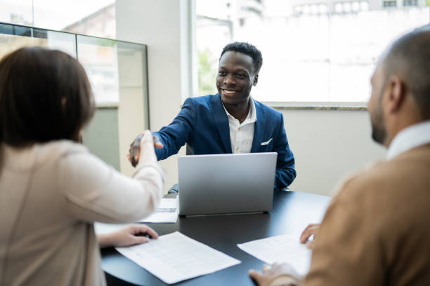 Customer shaking hands with car salesman buying a car Customer shaking hands with car salesman buying a car salesman stock pictures, royalty-free photos & images