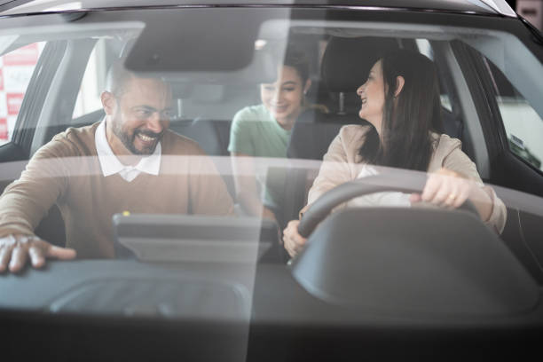 istock Family examining a car before buying 1356380331