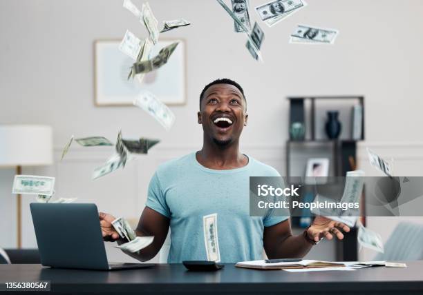 Shot Of A Young Businessman Managing His Money At Home Stock Photo - Download Image Now
