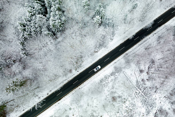 istock Road through wintery landscape - aerial view 1356380679
