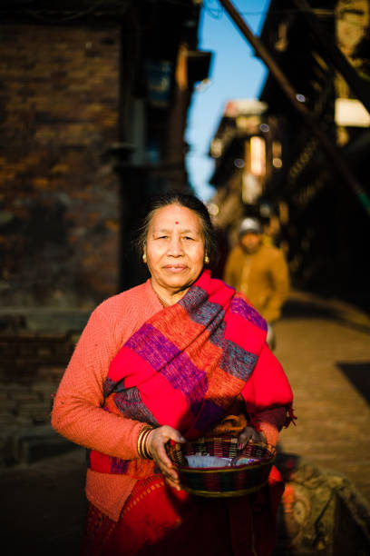 6th Feb, 2020. Bhaktapur, Nepal. A old women coming back home after the morning prayers in the temple. street of Bhaktapur, Nepal.