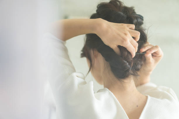 istock Young woman setting her hair 1356382726