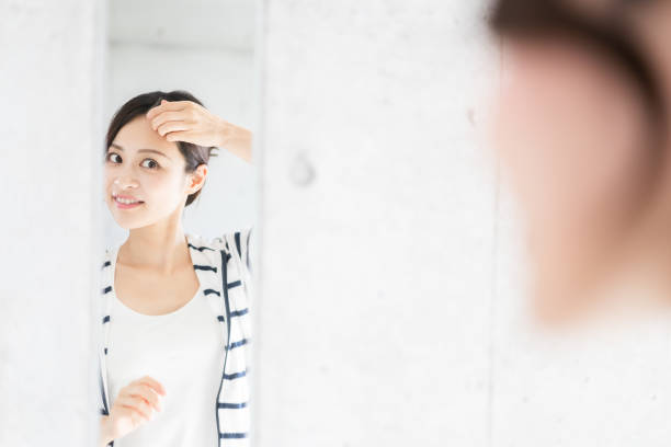 istock Young woman setting her hair 1356382747