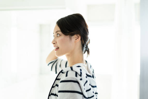 istock Young woman setting her hair 1356382758