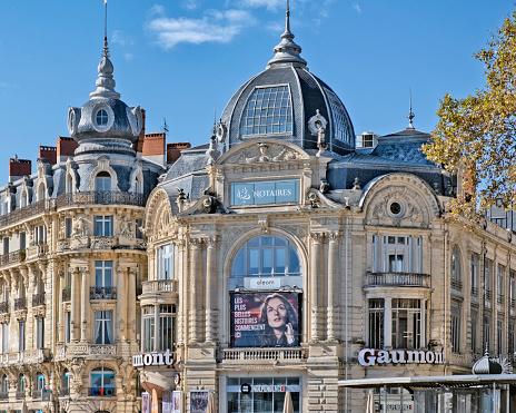 Montpellier, France - October 27, 2021: View of the Gaumont cinema and local architecture in the Place de la Comédie, Montpellier, France.
