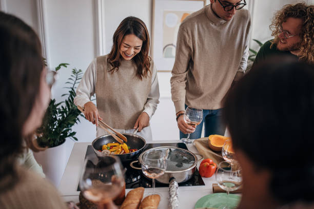 istock Friends making a meal together 1356383145