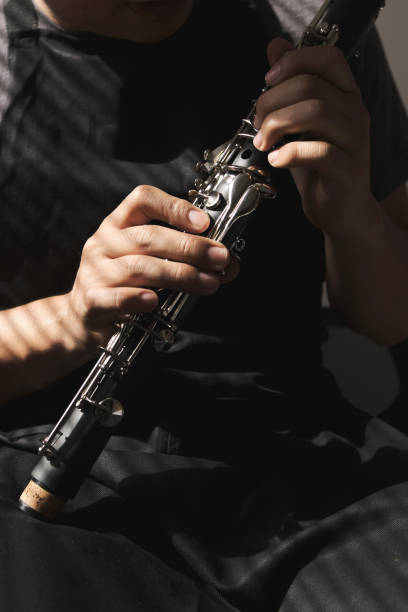 istock Unrecognizable man examining a clarinet body 1356383233