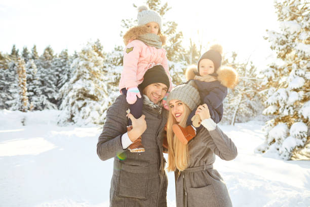 istock Family smiling in winter in a park 1356383804