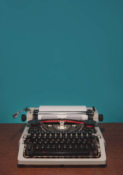 istock typewriter 70s with red printed ribbon on the table and blue background 1356386252