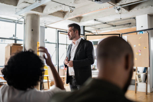 istock Businessman doing a presentation to a team 1356387058