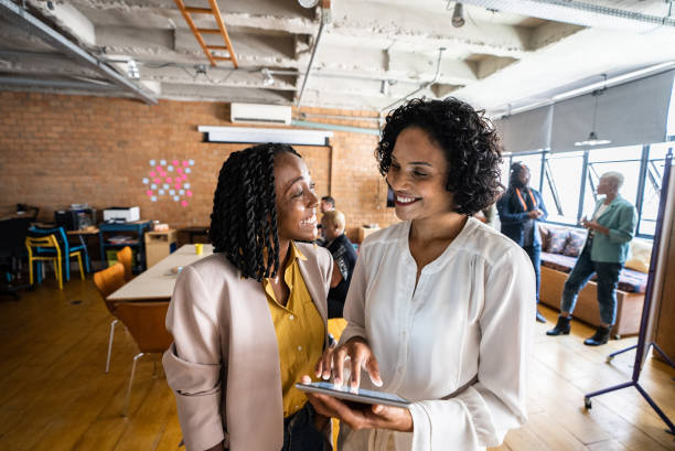 istock Two business women using digital tablet in the office 1356387138