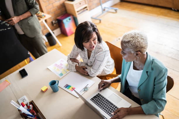 istock Business women doing a meeting using laptop in the office 1356387212