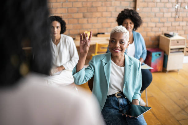 istock Business woman making a question to speaker in a conference 1356387253