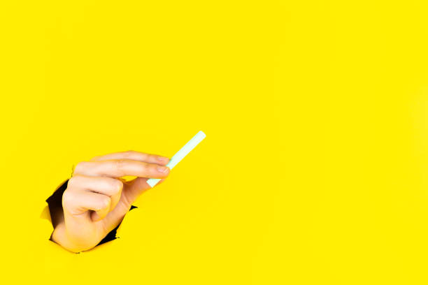 istock Hand is holding piece of chalk 1356387658