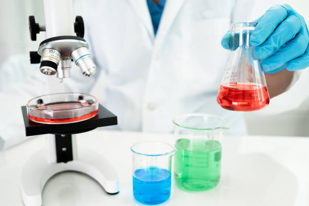 istock Asian scientist biochemist or microbiologist working research with a microscope in laboratory. For protect outbreak Coronavirus Covid19, bacteria and germs. 1356387863