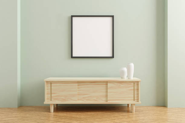 istock Black square poster frame mockup on wooden table in living room interior on empty pastel color wall background. 3D rendering. 1356389505