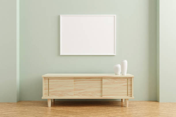istock White horizontal poster frame mockup on wooden table in living room interior on empty pastel color wall background. 3D rendering. 1356389522