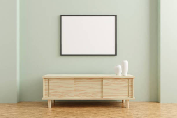istock Black horizontal poster frame mockup on wooden table in living room interior on empty pastel color wall background. 3D rendering. 1356389526