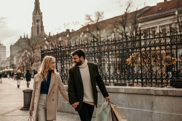 istock Married couple in city shopping 1356390435