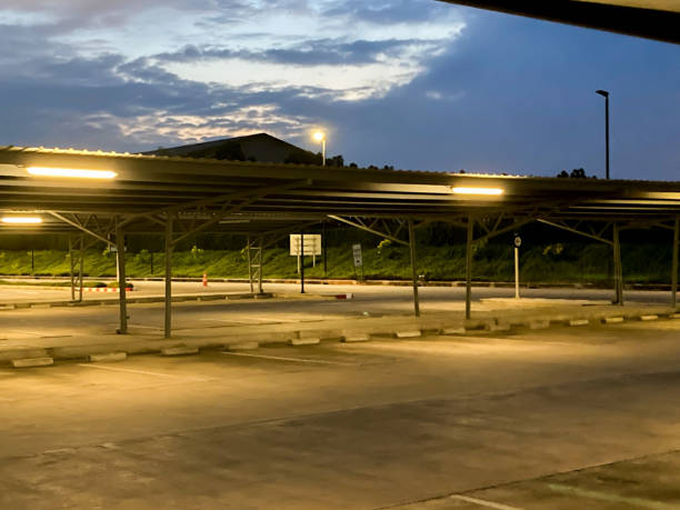 istock Parking lot without cars parked at night 1356390585