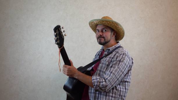 istock A man in a hat plays the guitar 1356391602