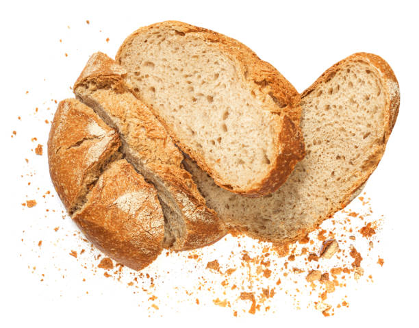 istock Freshly baked Bread with crumbs  isolated on white background.  Sliced, cutted wheat bread. Bakery, rustic  traditional food concept. Top view