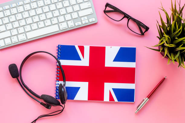 istock Student table desk with British flag and headphones. Online language courses 1356392818