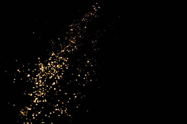 istock Golden blurred bokeh lights on black background 1356392914
