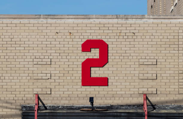 istock Number two in bold, red text against a beige brick background. 1356394298
