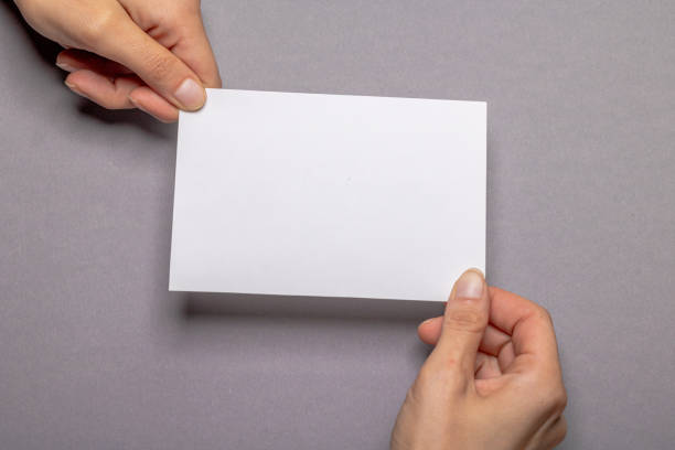 istock woman holding blank letter on gray colored background 1356394731