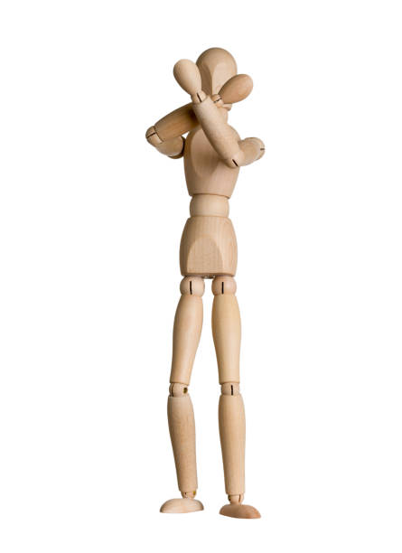 istock wooden dummy covered his head with hands from impact, blocking, isolated on white 1356395638