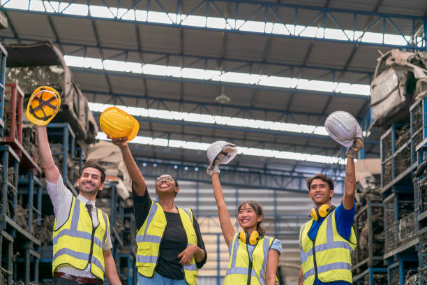 istock Group of technicians or foreman. Team of workers and engineer Excited engineer celebrating in parts warehouse. 1356395894