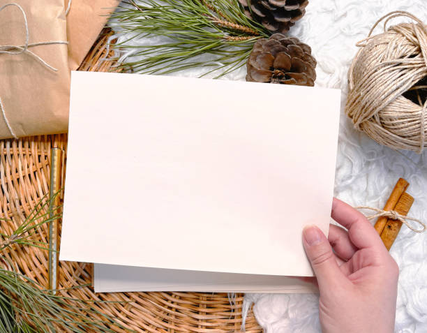 istock Christmas decorations, hand holding paper, background, 1356395960