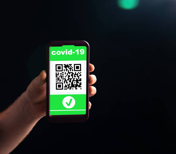 istock A mans hand holds a mobile phone with a digital certificate against Covid-19 in front. Business and tourism concept of travel during coronavirus pandemic 1356396138