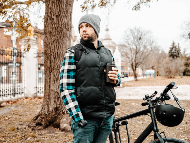 istock Young man with prosthetic arm having a coffee 1356397163