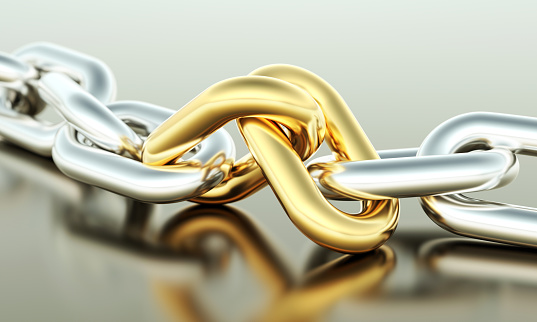 Two gold links with silver chain. Partnership or teamwork concept