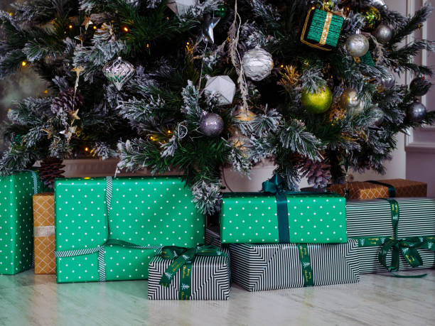 istock green gift boxes under a Christmas tree decorated with colorful toys 1356398802