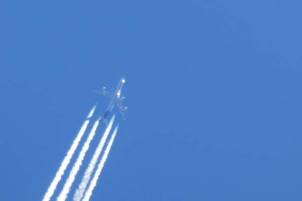 istock plane in the sky leave trails 1356399803