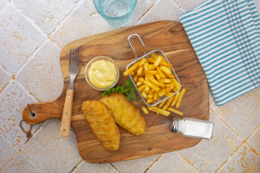 breaded fish with fries on a tabletop
