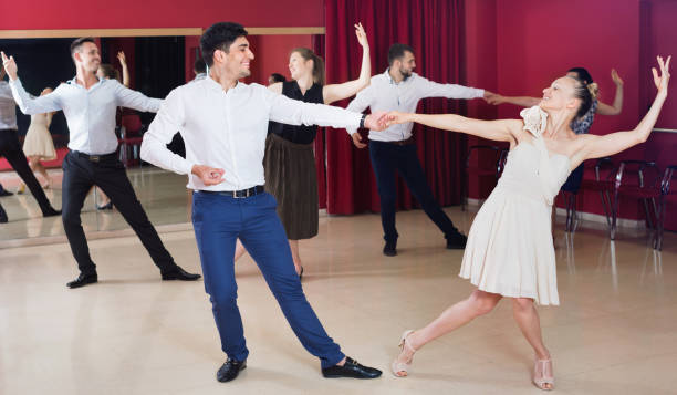 istock People learning to dance waltz in dancing class 1356404046