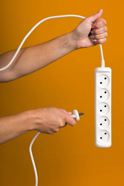 istock power strip with five sockets in hand on yellow background 1356404155