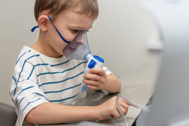 istock boy at home breathing medicine in a mask with a nebulizer 1356405133