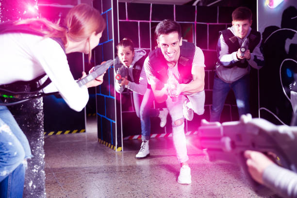 istock Guy with friends playing laser tag 1356406719