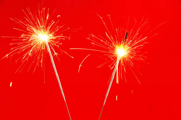 istock Two sprinklers shoot on a red background 1356407878
