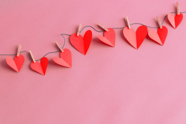 istock Paper hearts hanging on a clothesline with space for copy 1356409036