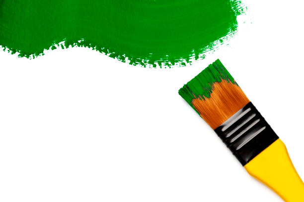 istock Paintbrush with green paint stroke (isolated on white) 1356409456