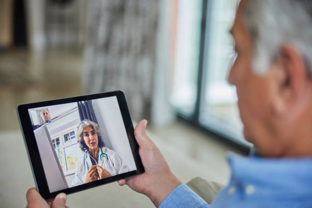 istock Man Having Remote Consultation With Doctor At Home Using Digital Tablet 1356409496