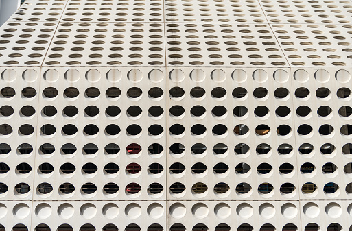 Wall of a public parking lot with hollow circles to allow the entry of light and air from outside.\n3420 Collins Avenue, Miami Beach Florida 33140. USA